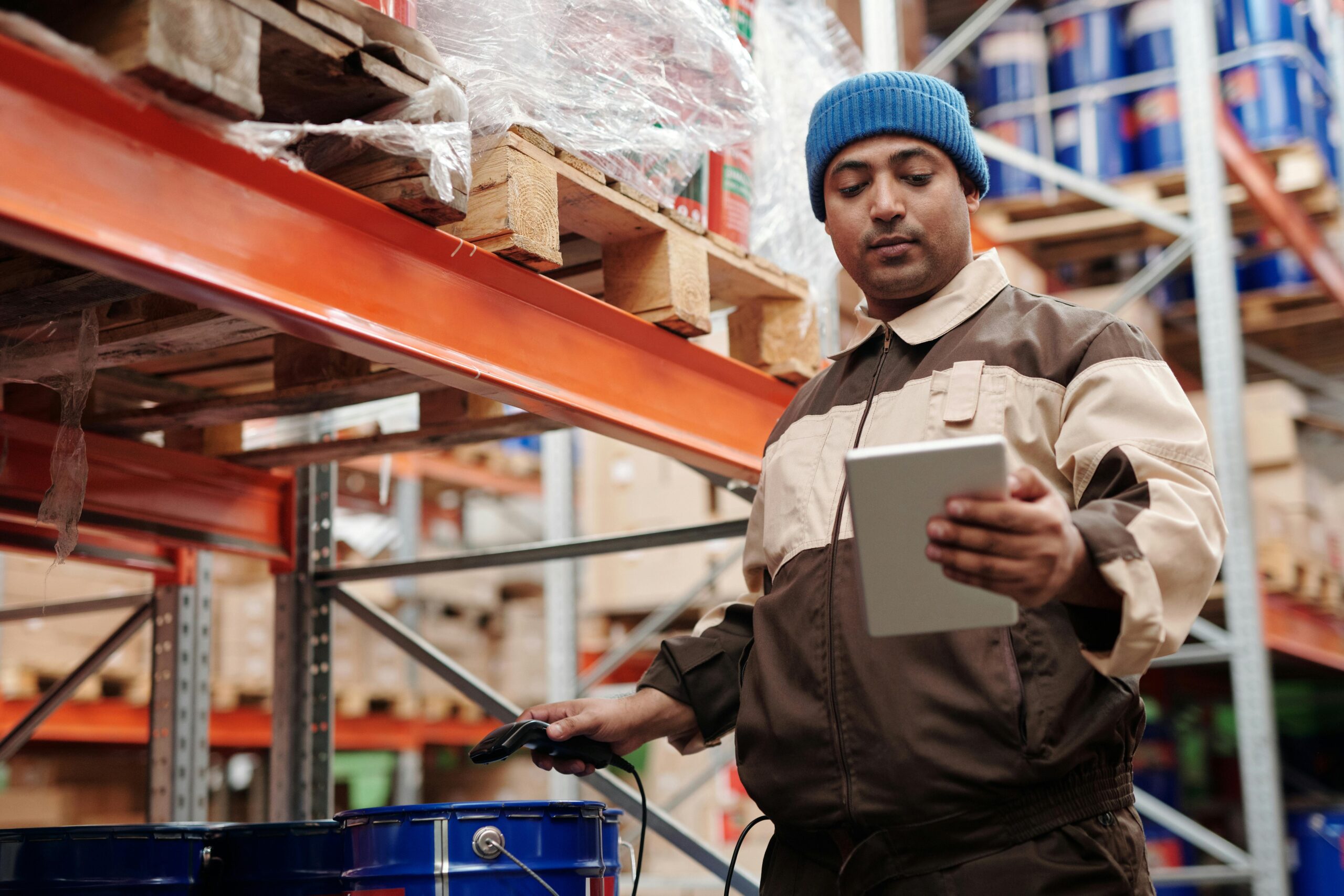 Man Holding Digital Tablet in a warehouse